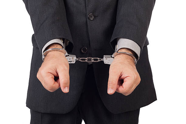 istock business man with a black suit in handcuffs 157663932