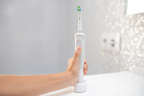 Children use electric toothbrush