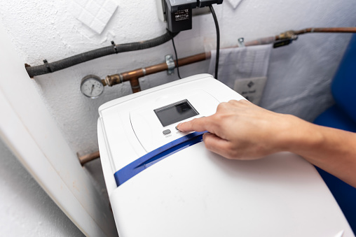 Programming pressurized water softeners in a home shed