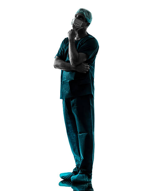 istock doctor surgeon man thinking with face mask full length silhouett 157666136
