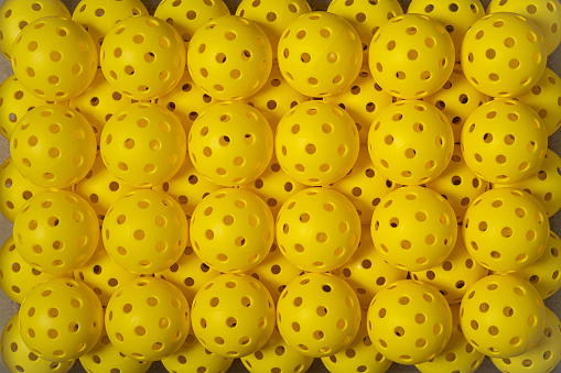 Group od yellow Pickleball lined up