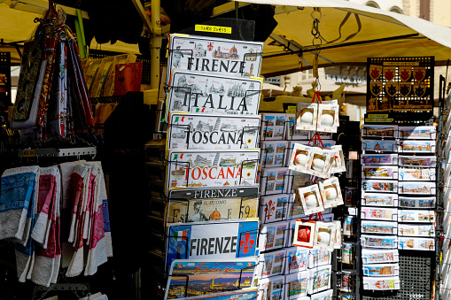 Florence, Italy - April 15, 2023: Colorful souvenirs are displayed outside the market stall, which also offers other small stuff  from this wonderful city.