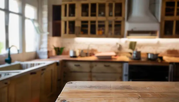Photo of Blurred image of modern kitchen interior for background usage. Vintage tone.