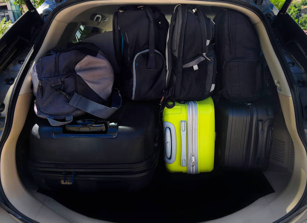 istock A Stack of Bags And  Luggage in Car Trunk 1576706589