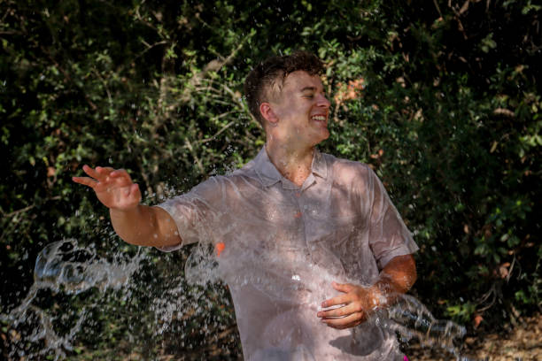 istock Young man wet at the park 1576712221