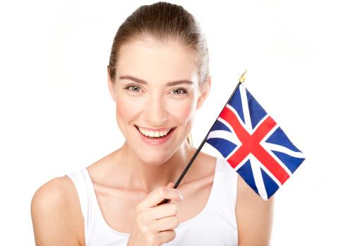 Beautiful smiling young woman holden British flag. Adobe RGB