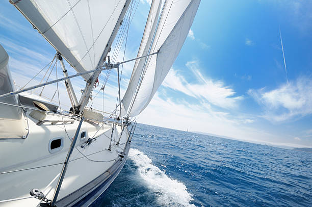 Yacht under sail on the sunny day stock photo