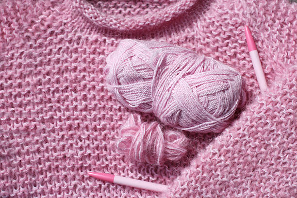 istock Knitted pink sweather, circular needle and two kind of wool 157672126