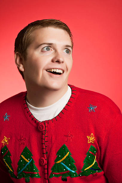 Weird Christmas Sweater Man A very excited man wearing a holiday sweater christmas ugliness sweater nerd stock pictures, royalty-free photos & images