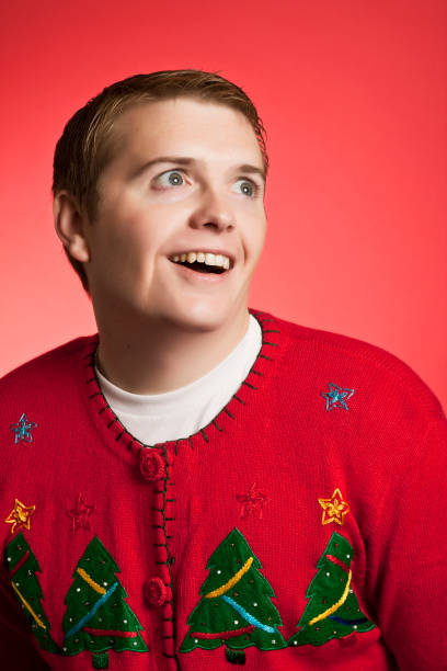 Weird Christmas Sweater Man A very excited man wearing a holiday sweater christmas ugliness sweater nerd stock pictures, royalty-free photos & images