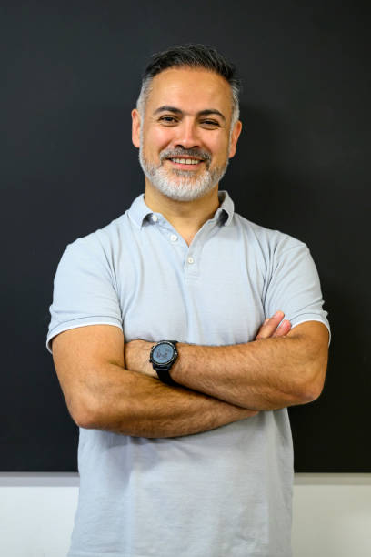 istock Smiling teacher standing at the blackboard 1576723871