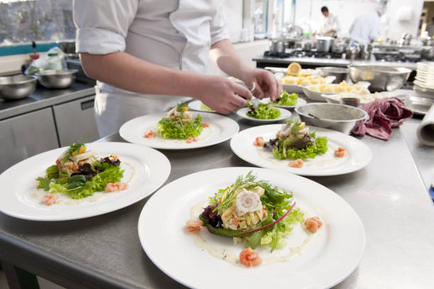 istock chef preparing white plates with seafood salad 157672406