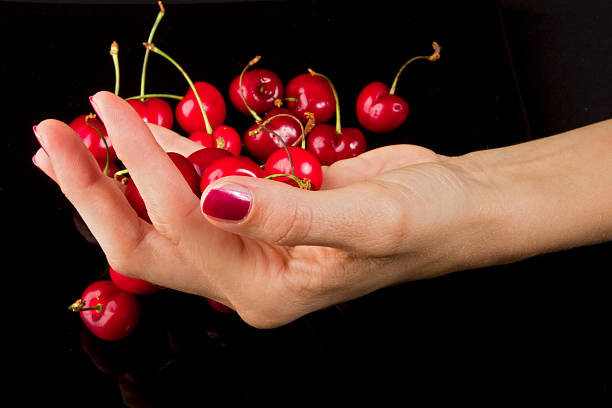 Cherry fresh on black background close up.