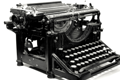 A black and white shot of an antique typewriter's keyboard.