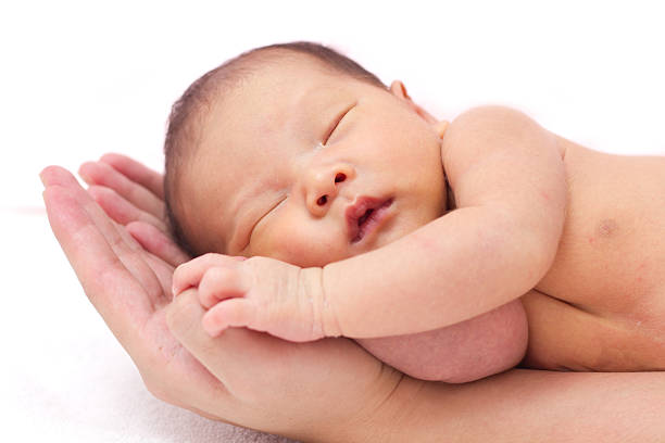 istock A newborn baby in its mothers hands 157672878