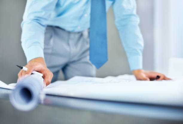 istock Cropped image of an architect with marker designing on blueprint 157673371