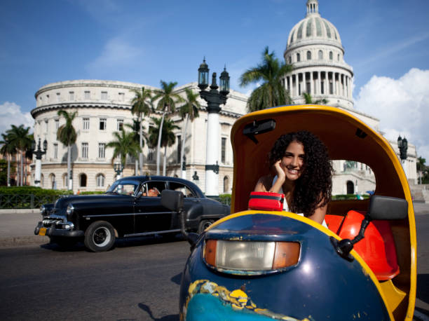 istock Attractive cuban woman posing by the El Capitolio 157673416