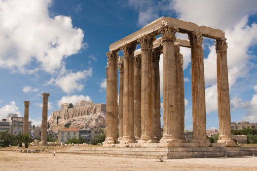 Corintian columns of the Temple of Olympic Zeus and Acropolis in the background. Greece.