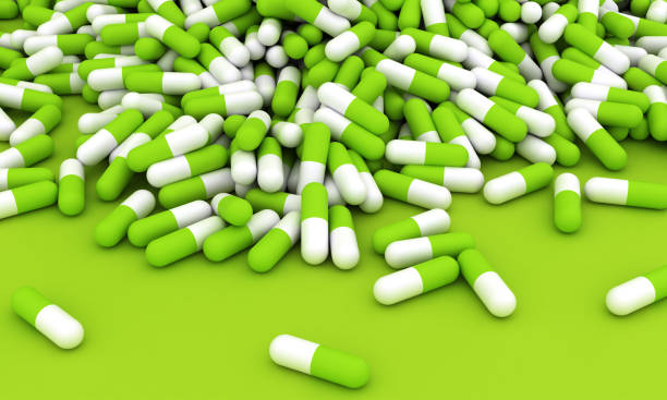 istock Green pills on green background with copy space 1576737684