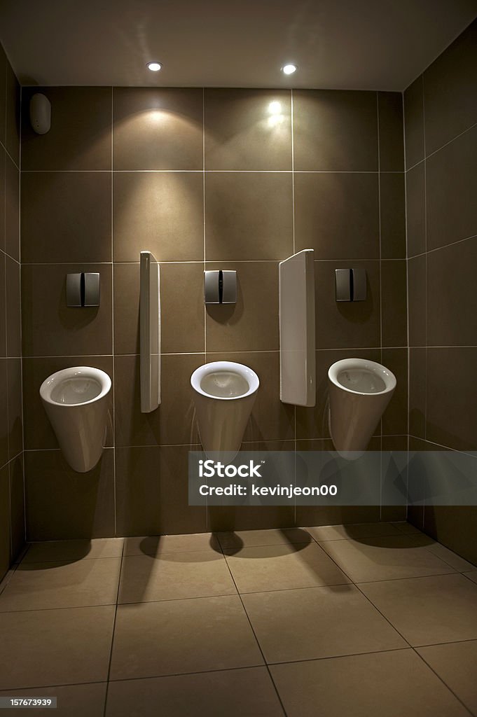 Urinals Clean urinals in men's public restroom Bathroom Stock Photo