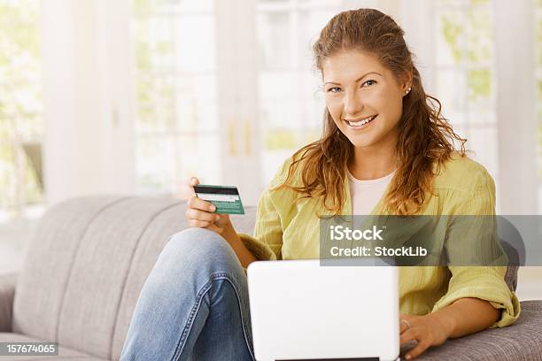 Happy Young Woman Purchasing On Laptop With Credit Card Stock Photo - Download Image Now