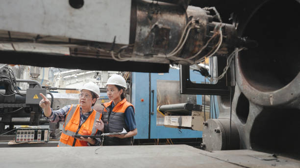 Senior female supervisor training engineer in factory.