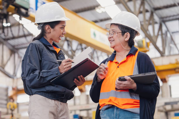 Happy Females Engineer discuss with cheerful in a factory stock photo