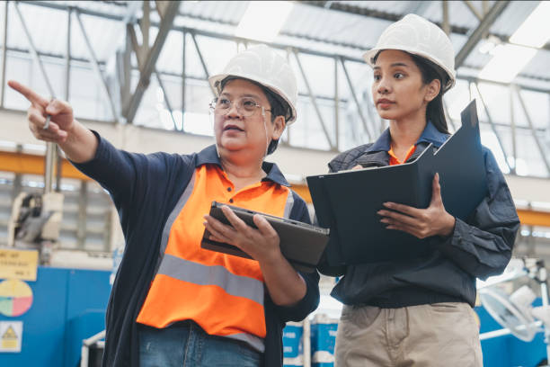 istock Senior female supervisor training engineer in factory. 1576741352
