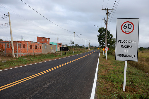 itaju do colonia, bahia, brazil - july 23, 2023: Signpost indicates speed limit of 60 kilometers per hour on state road BA 667 in the city of Itaju do Colonia in southern Bahia.