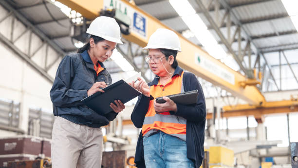 istock Senior female supervisor training engineer in factory. 1576741369