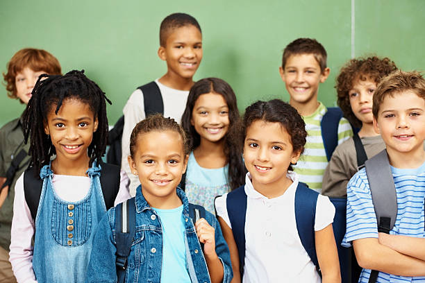 istock Portrait of a group elementary school students standing together 157674368
