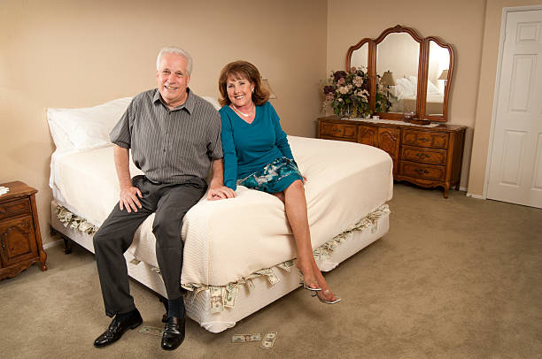 Money Under Mattress Couple stock photo