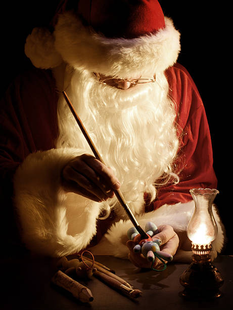 istock Santa Claus painting a toy 157674738