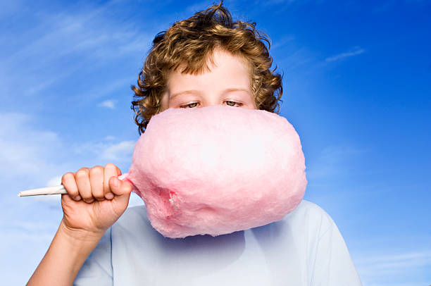 Boy Holding a Candy Floss or Cotton Candy http://i895.photobucket.com/albums/ac158/jameswhittaker_bucket/iStockBanner2011ChildrenMaster.jpg child cotton candy stock pictures, royalty-free photos & images