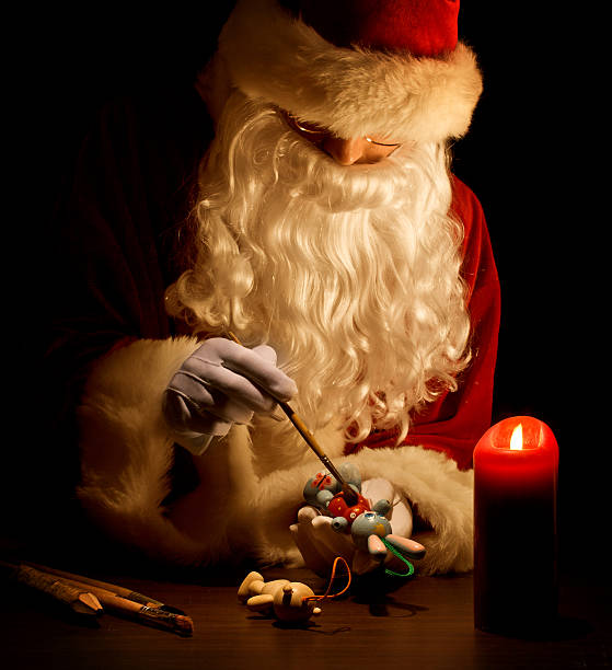 istock Santa Claus painting a toy 157674747