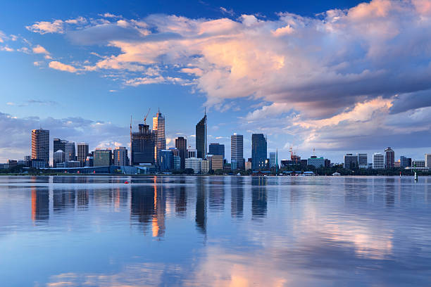 Skyline of Perth, Australia across the Swan River at sunset The Central Business District of Perth, Australia. Shot from across the Swan River. perth australia photos stock pictures, royalty-free photos & images