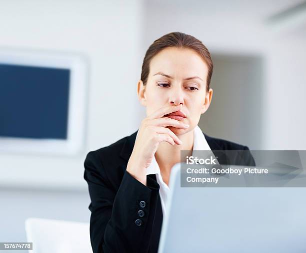 Negócios Mulher Sentada Cuidadosamente Na Frente De Um Computador Portátil - Fotografias de stock e mais imagens de Computador