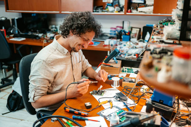 istock Technician Repairing Electronic Equipment In A Workshop 1576748266