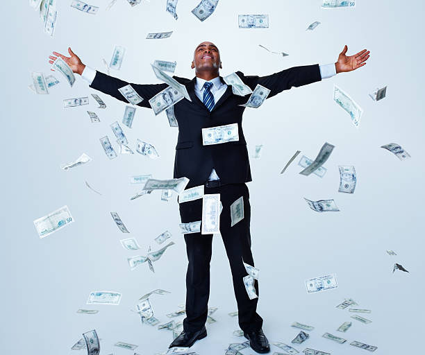 istock Happy successful business man under money rain against white 157674839
