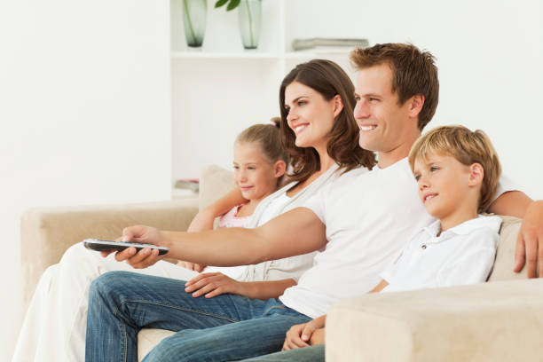 istock Smiling Family Sitting On A Couch 157674870