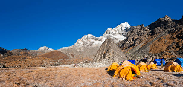istock Base camp tents wilderness camping Himalaya mountain peaks panorama Nepal 157674982