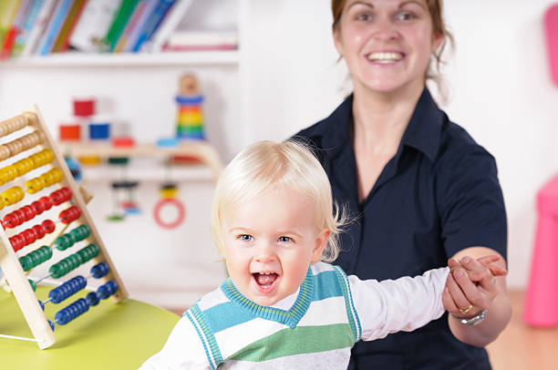 istock Baby/ Toddler Walking While Being Supported By His Carer 157675058