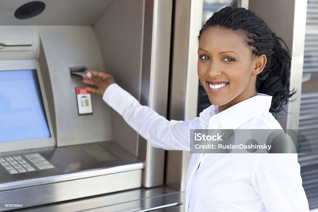 Woman using credit card to withdraw cash money  20-24 Years Stock Photo