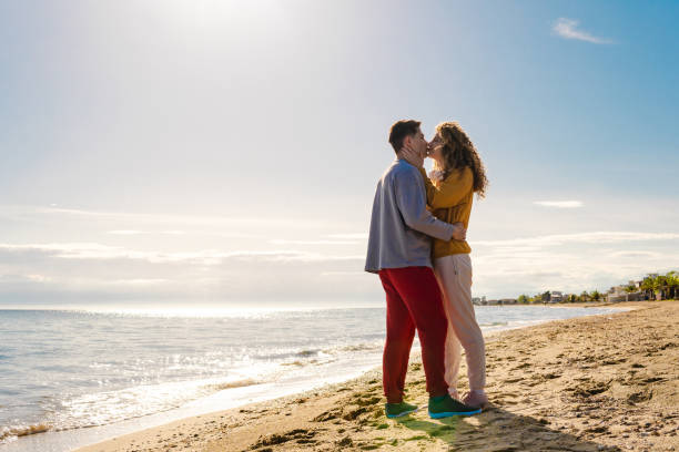 istock Young couple enjoying in love on the beach 1576751408
