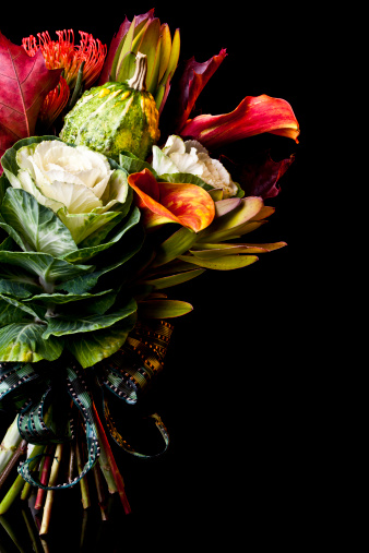 Large bouquet of seasonal flowers isolated on a black background