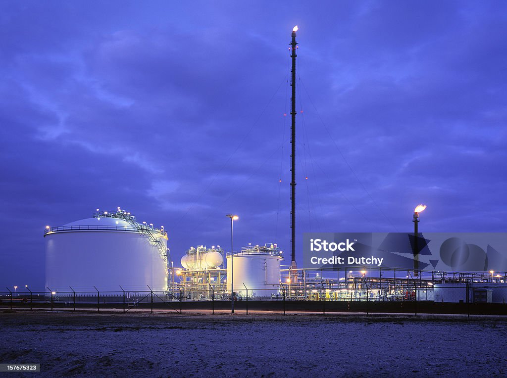 Oil refinery at dusk.  Flame Stock Photo
