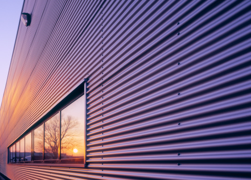 Sunset reflecting in window of newly built warehouse. High-end scan of 6x7cm transparency.