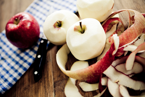 Peeled apples on a wooden table.