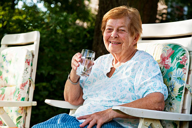 istock senior woman drinking water 157675788
