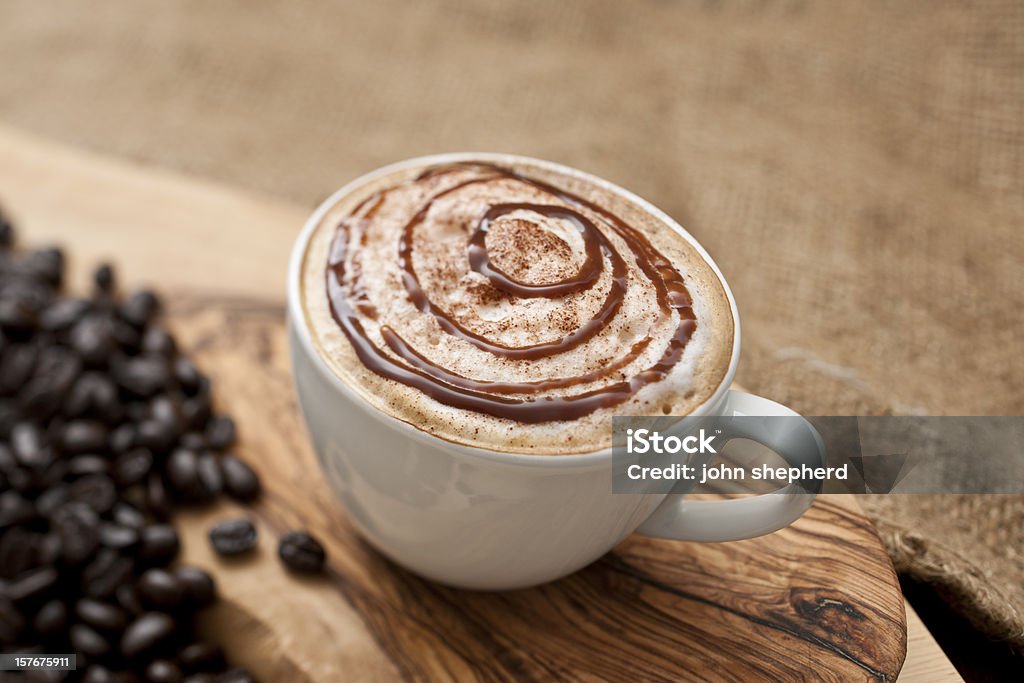 Cappuccino topped with swirls of chocolate sauce Cappuccino topped with swirls of chocolate sauce. Mocha Stock Photo